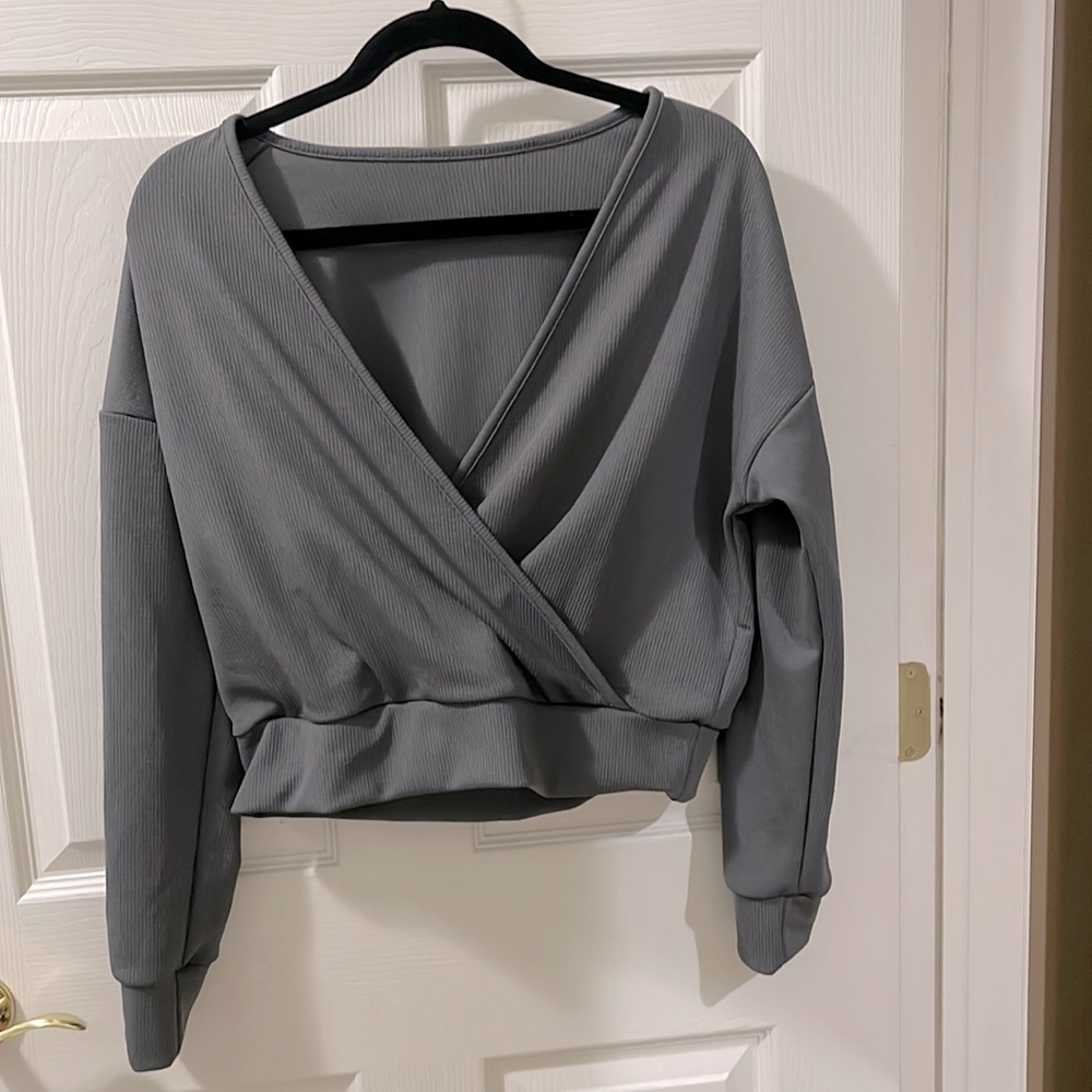 Gray long sleeve sweater with low styled front